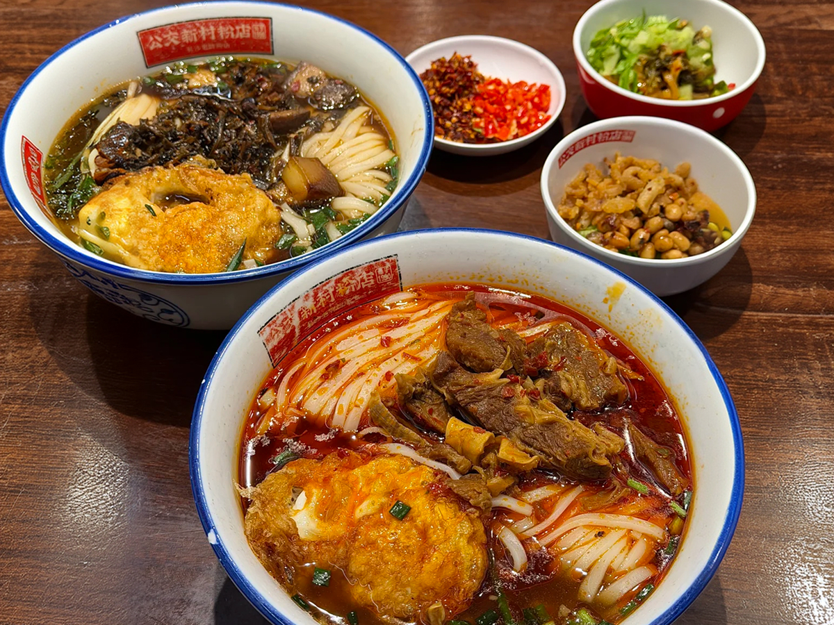 Bowl of hot rice noodles with meat and chili sauce