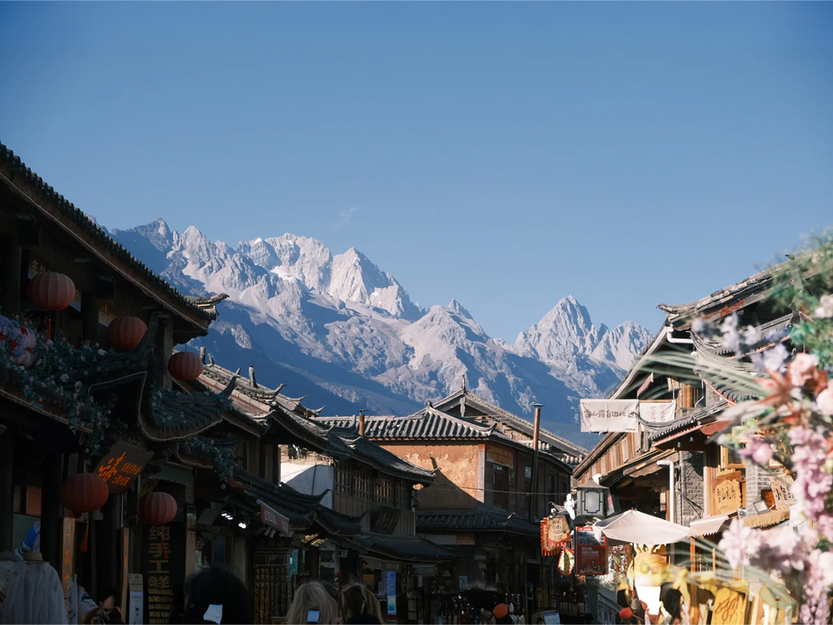 Baisha Ancient Town street with snow mountains in the distance