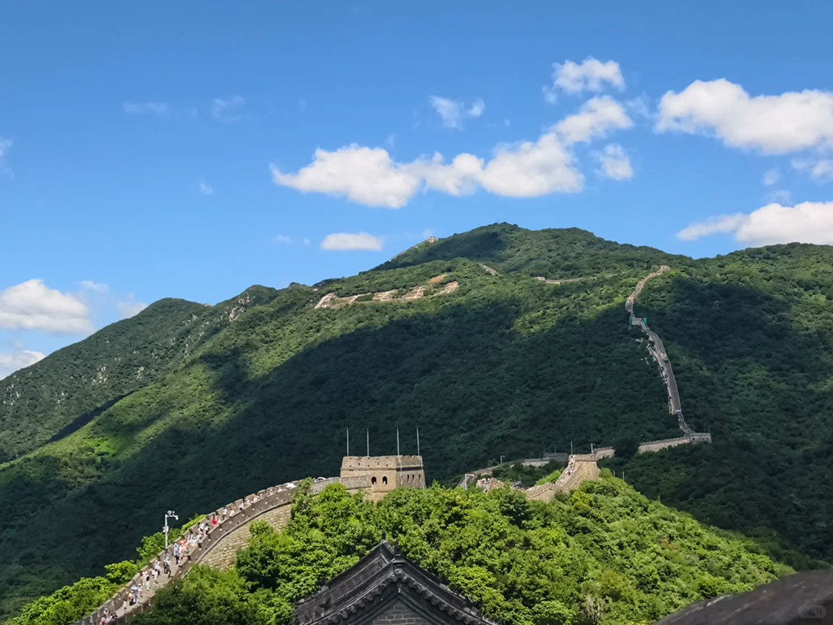 Restored Mutianyu Great Wall winding over green mountains