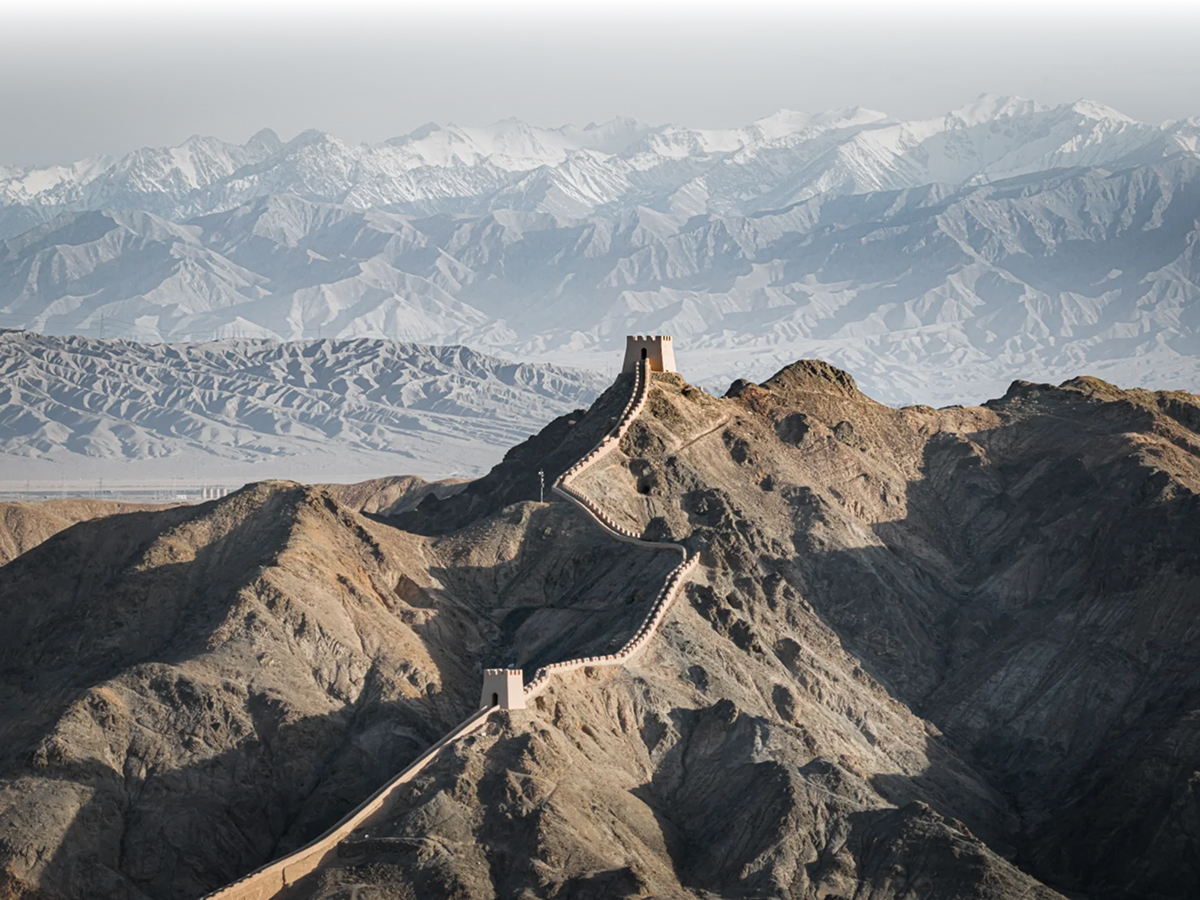 Jiayuguan Great Wall in desert with mountains