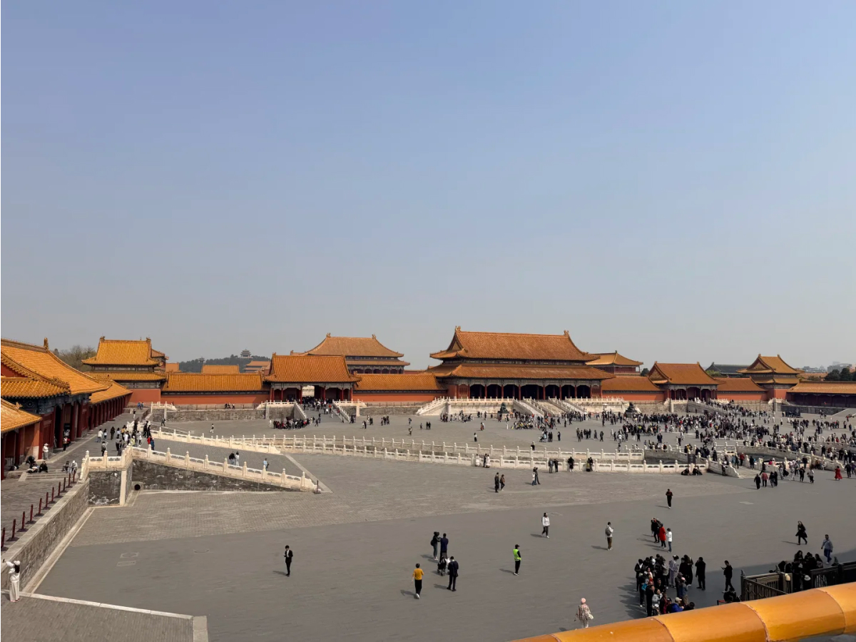 Taihe Gate square with red walls and visitors walking